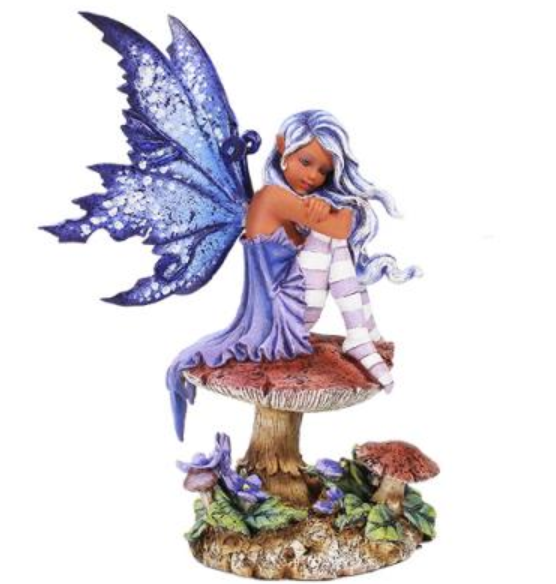 Violet fairy figurine sitting on mushroom with blue glitter wings